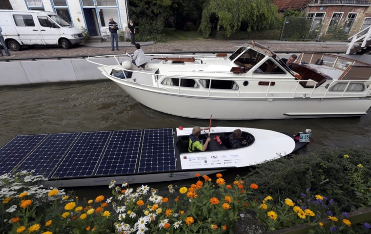 The solar boat Midnight Sun from Finland passes the village Kimswerd during the Dong Energy Solar Challenge in Leeuwarden, the Netherlands, July 13.