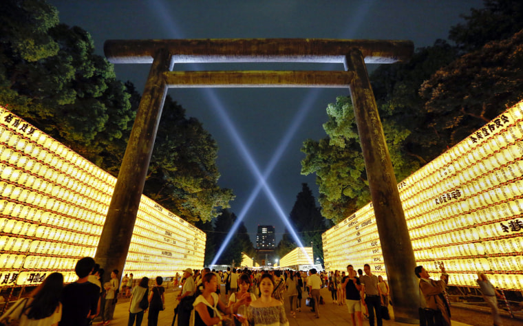 People visit the Yasukuni Shrine on the eve of the three-day Mitama-Matsuri, or Sould Festival, in Tokyo on July 13, 2012. The summer festival is held to comfort souls of the war dead.
