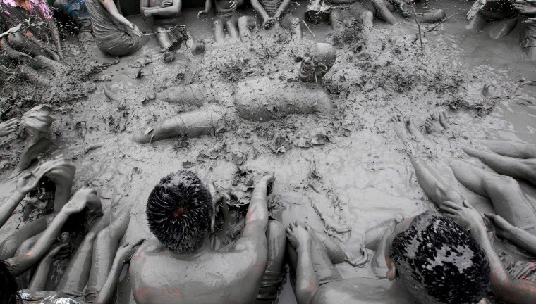 Festival visitors are covered with mud during the 15th Boryeong Mud Festival on Daecheon beach in Boryeong City, 190km west of Seoul, South Korea, July 15 2012.