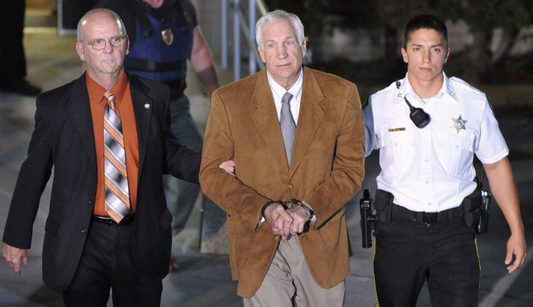 Former Penn State assistant football coach Jerry Sandusky leaves the Centre County Courthouse in handcuffs after his conviction in a child sex abuse trial in Bellefonte, Penn. on June 22, 2012.