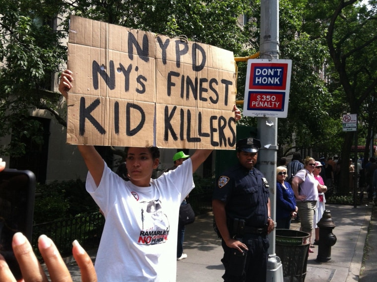 In front of an officer, a protester voices her displeasure with the New York Police Department during a June silent march down New York's Fifth Avenue.