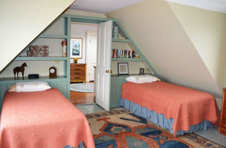 One of the bedrooms is a charming little space tucked under the house's eaves.
