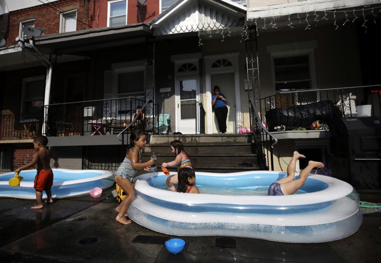 Veronica Caines, foreground from right, 6, Kianna Roman, 4, Juliann Esola, 5, Aliyah Nguyen, 5, and Jayden Jones, 2, cool off in a wade pool under the watch of Brittany Gonzalez, background, Monday, July 16, in Philadelphia. Temperatures in Philadelphia reached the low 90s on Monday.