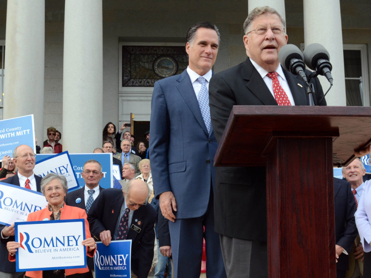 Mitt Romney listens as former New Hampshire Governor John Sununu endorses him for president outside the Statehouse October 24, 2011 in Concord, New Hampshire.