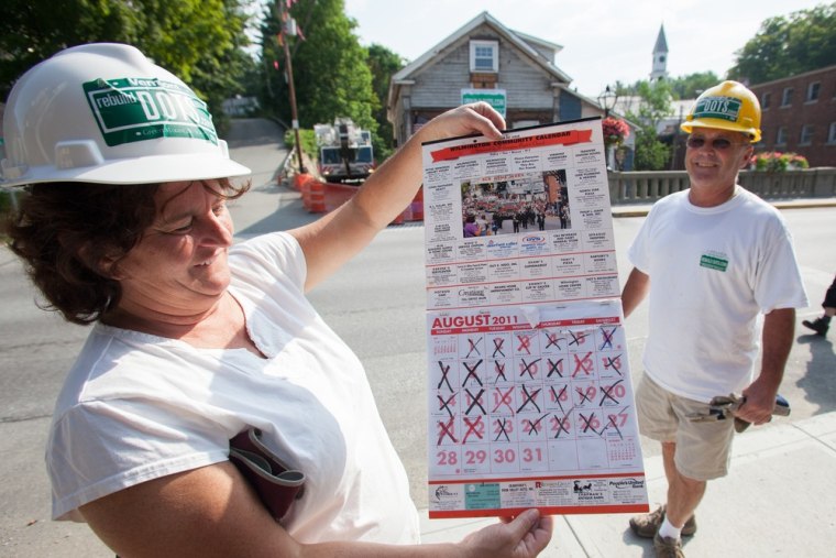 Patty and John Reagan, co-owners of Dot's Restaurant, display a calendar from the kitchen of their restaurant with each day checked off up until the day Tropical Storm Irene came last August.