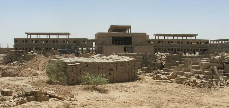 The Khan Bani Saad Correctional Facility, about 12 miles northeast of Baghdad, is seen with unused building materials nearby. The site is a chronicle of U.S. government waste, misguided planning and construction shortcuts costing $40 million.
