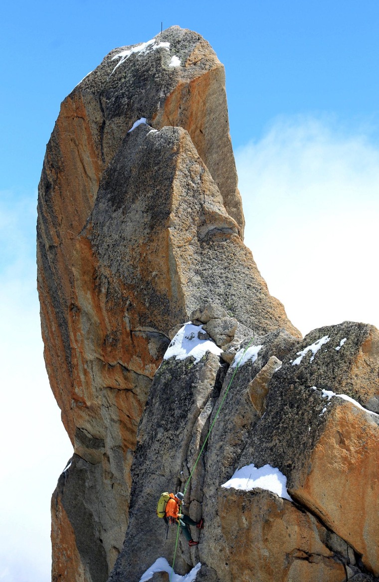 A climber tackles a part of the Mont Blanc mountain near Chamonix ski resort in France on July 17, several days after an avalanche in the area claimed nine climbers.