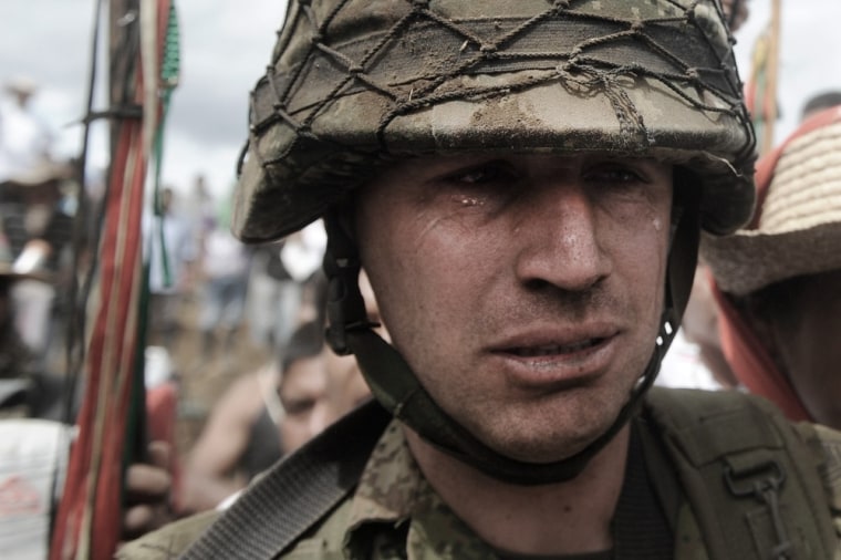 Army sergeant Rodrigo Garcia leaves with tears in his eyes after he was forced out of his military post on Mount Berlin on July 17, 2012.
