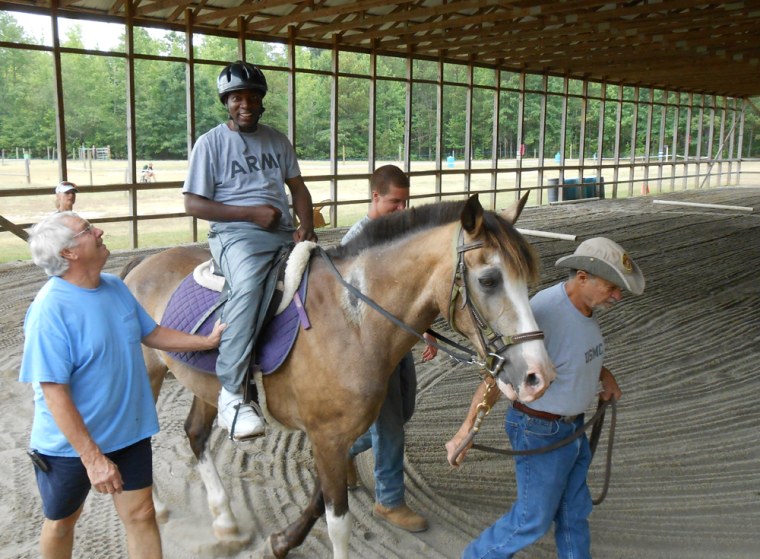 Kelvin Bonner spends time on a horse named Buck at the Calvin Center in Hampton, Ga. Buck is part of an equestrian program that aims to help veterans overcome daily emotional and physical obstacles.