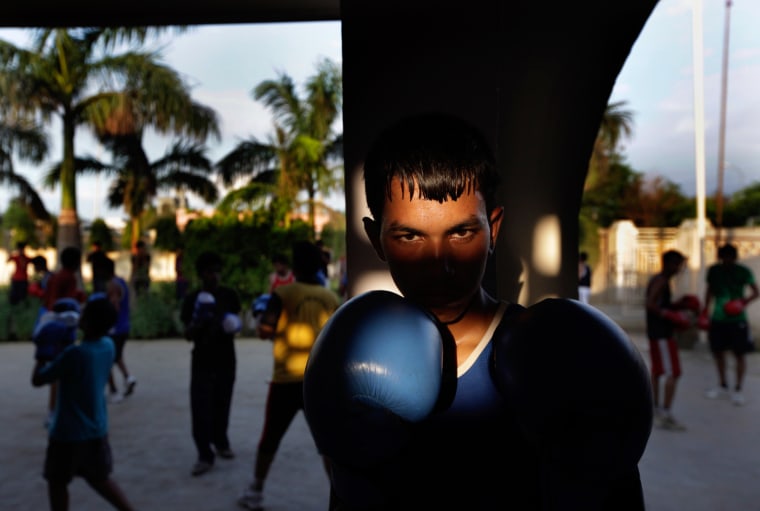 An Indian amateur boxer prepares for a training session at the Bhiwani Boxing Club in Bhiwani, 76 miles west from New Delhi, India, on July 11.