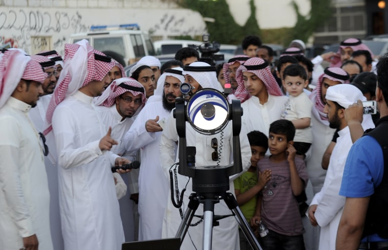 Saudis use a telescope to monitor the new moon of Ramadan as astronomers and scholars of Islam debate when the holy Muslim month of Ramadan begins, in the Saudi city of Taif on Thursday, July 19. The start of the fasting month, when the faithful abstain from eating from dawn to sunset, is determined by the sighting of the new moon.