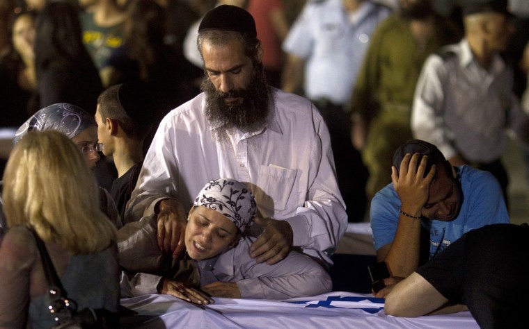 Relatives mourn five Israelis killed during an explosion on a tour bus in Burgas, Bulgaria, after their arrival at the Ben Gurion International Airport near Tel Aviv on July 20, 2012.