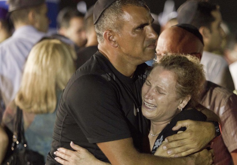 An Israeli family cries during a military ceremony for victims killed in an attack in Bulgaria, at the Ben Gurion International Airport near Tel Aviv on July 20, 2012.