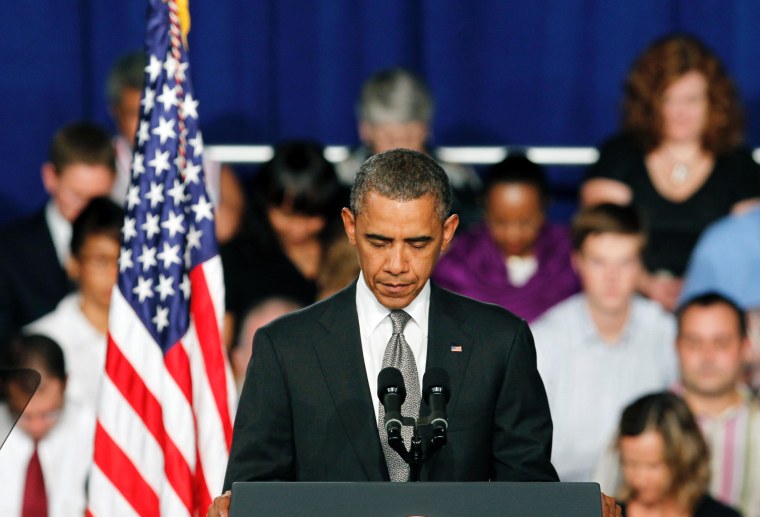 President Barack Obama takes a moment of silence for the events in Colorado during a campaign stop in Fort Myers, Florida.
