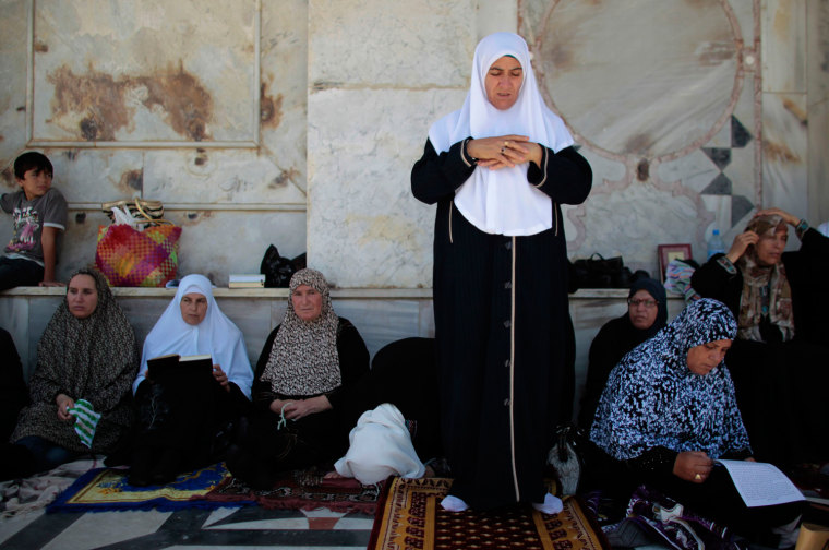 Palestinian women pray outside the Dome of the Rock on the compound known to Muslims as Noble Sanctuary and to Jews as Temple Mount in Jerusalem's Old City on July 20. Israeli police said Palestinian males over the age of 40 would be permitted to enter the compound in Jerusalem's Old City on Friday.