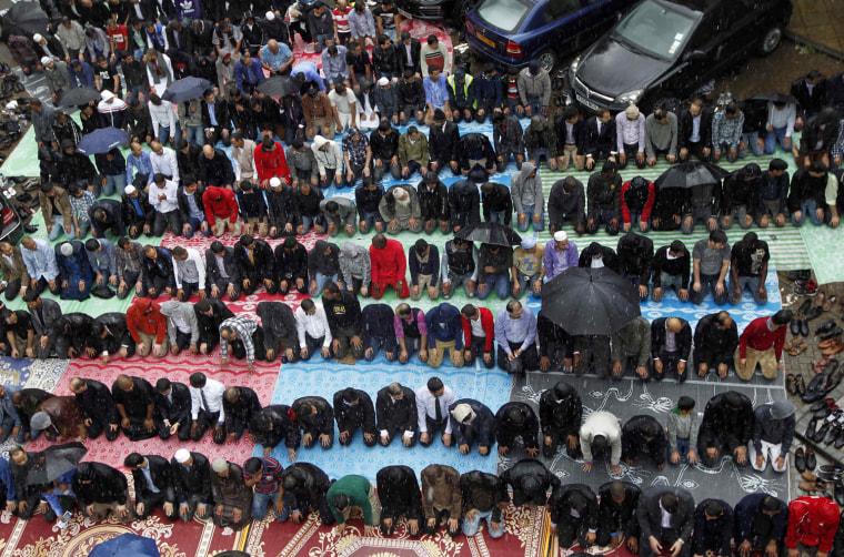 Muslims attend Friday prayers at the courtyard of a housing estate in east London on July 20.