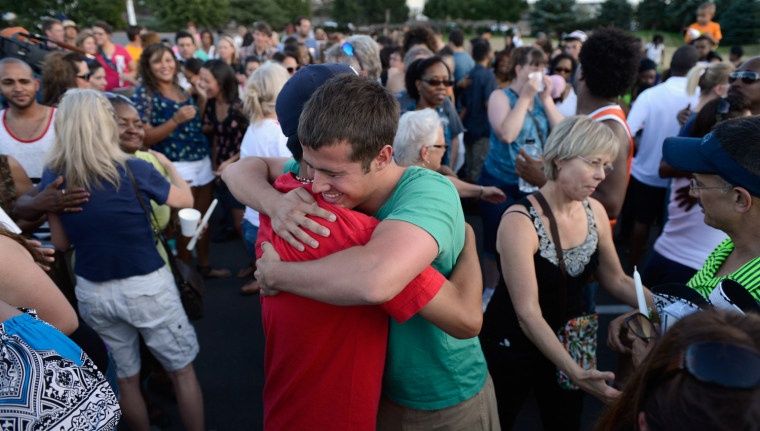 Mourners at a vigil near theater where 12 people were killed July 20, 2012 in Aurora, Colo.