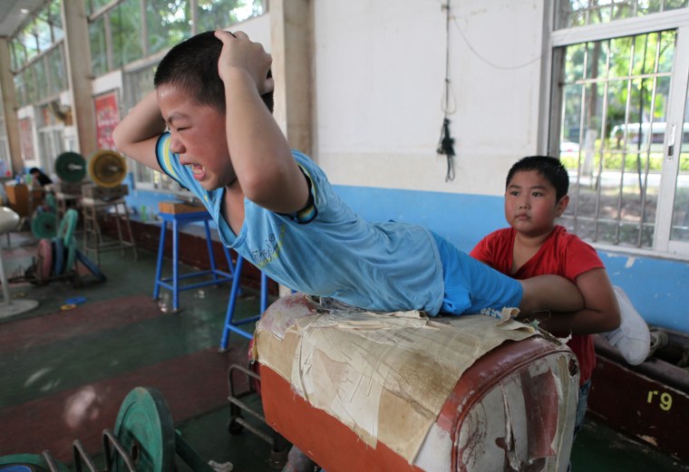 Young Chinese boys training at a weightlifting school in Xiamen, Fujian province.