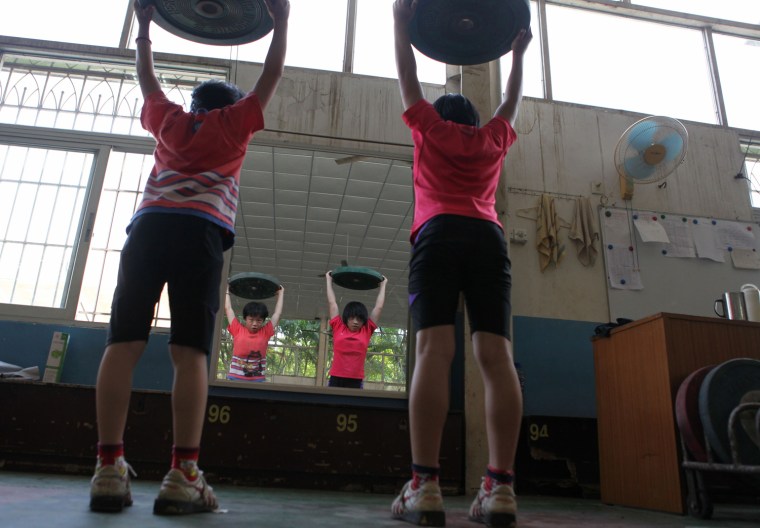 Two Chinese girls training at a weightlifting school on July 11, 2012