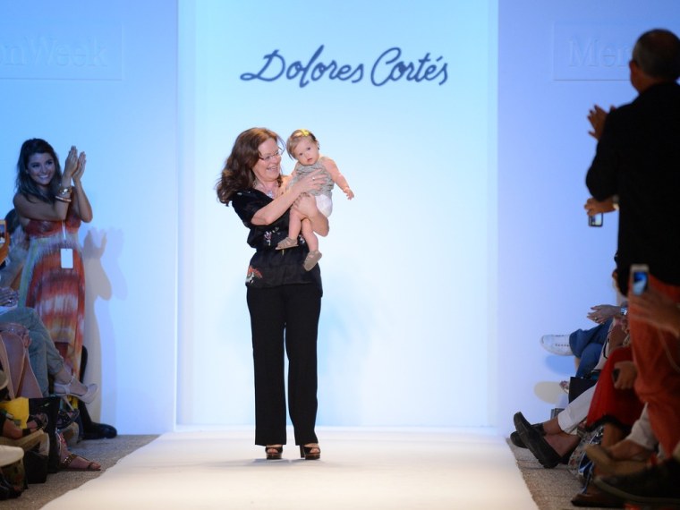 A sweet moment: Designer Dolores Cortes, holding 10-month-old model Valentina Guerrero, walks the runway at the Dolores Cortes show during Mercedes-Benz Fashion Week Swim 2013 on July 20 in Miami.