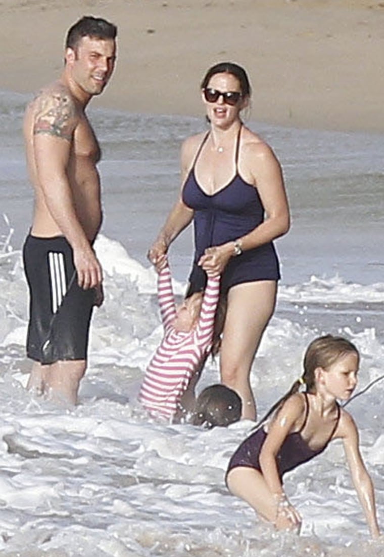 Moms everywhere rejoice Jennifer Garner's post-baby choice of a one-piece 'Mom-suit'  while cavorting on the beach with  hubby Ben Affleck and kids.