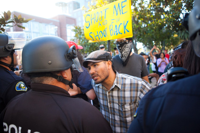 Protesters clash with police during a demonstration to show outrage for the shooting death of Manuel Angel Diaz, 25, at Anaheim City Hall on Tuesday in Anaheim, Calif. Diaz was fatally shot on Saturday by police.