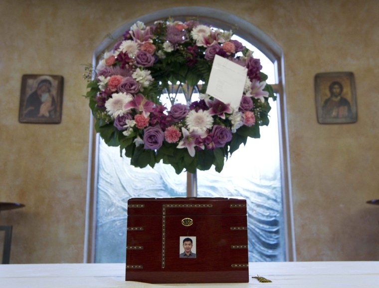 The urn containing the ashes of Jun Lin sits in a funeral home prior to the funeral services in Montreal, July 26, 2012. According to the police, Porn Actor Luka Magnotta murdered Lin, dismembered his body and posted a gory video of the crime online. Magnotta faces first degree murder charges.