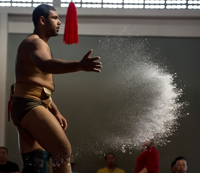 Cassio Gomes of Brazil throws a handful of salt into the ring during the Sumo wrestling South American Championship on July 22.