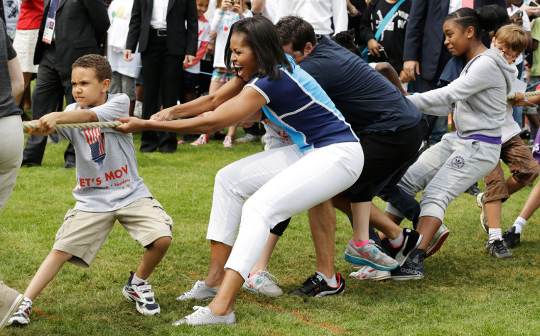 U.S. first lady Michelle Obama plays with schoolchildren during a 'Let's Move!' event for about 1,000 American military children and American and British students at the U.S. ambassador's residence in London, ahead of the 2012 Summer Olympics, Friday, on July 27.