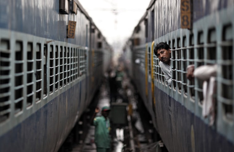 A passenger looks through the window of a train as he waits for electricity to be restored at a railway station in New Delhi July 31. Grid failure hit India for a second day on Tuesday, cutting power to hundreds of millions of people in the populous northern and eastern states including the capital Delhi and major cities such as Kolkata.