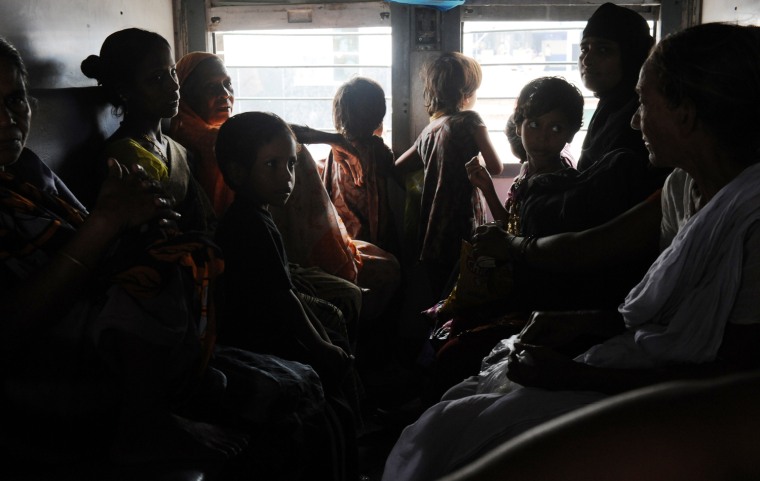 Indian women and children wait inside a darkened train carriage at a railway station in New Delhi on July 31. A massive power failure hit India for the second day running as three regional power grids collapsed, blacking out more than half the country in a crisis affecting over 600 million people.