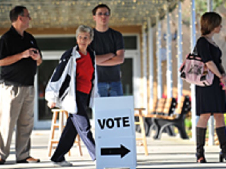 People wait before Republican presidential hopeful Newt Gingrich visits a voting precinct at the First Baptist Church of Windermere January 31, 2012 in Orlando, Florida.