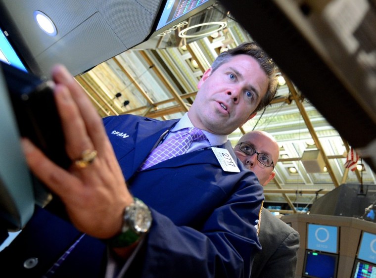 Traders work on the floor of the New York Stock Exchange on Friday.