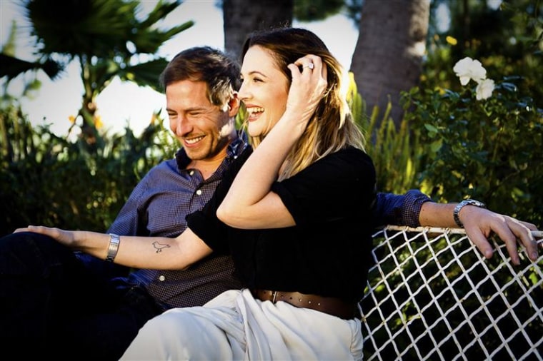 Actress Drew Barrymore shows off her engagement ring as she sits with her fiance Will Kopelman on Jan. 5, 2012.