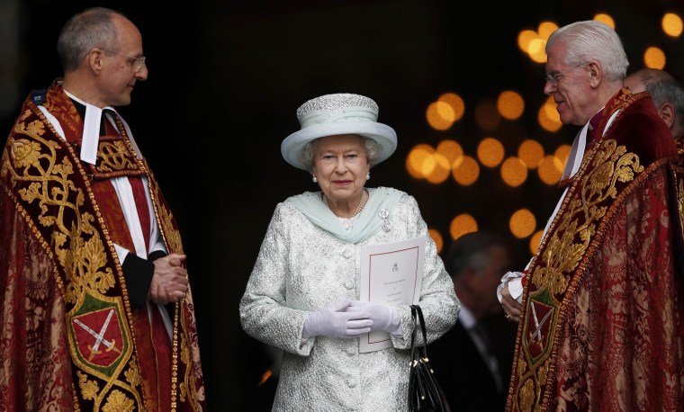 Britain's Queen Elizabeth smiles as she leaves St Paul's Cathedral with its Dean, David Ison and the Canon Pastor, Michael Colclough (right) following a thanksgiving service to mark her Diamond Jubilee in central London on June 5.