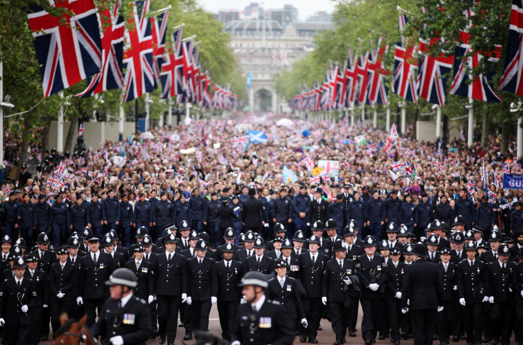 The crowd is escorted down The Mall during the Diamond Jubilee carriage procession after the service of thanksgiving at St.Paul's Cathedral on the Mall on June 5, in London, England.