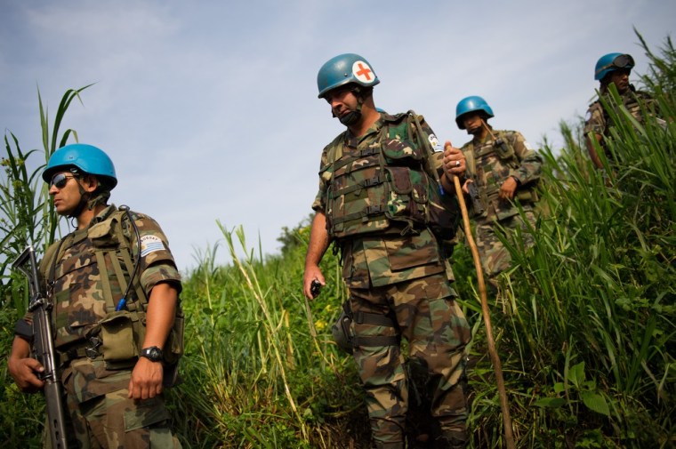 Uraguayan peacekeepers from the United Nations Organization Stabilisation Mission in Congo (MONUSCO) patrol around the village of Katoyi in Masisi territory in the Democratic Republic of the Congo's North Kivu province. The UN has deployed a platoon of peacekeepers in Katoyi following reports of massacres in the area, with reports of over a hundred people killed in the area since May 14 of this year.
