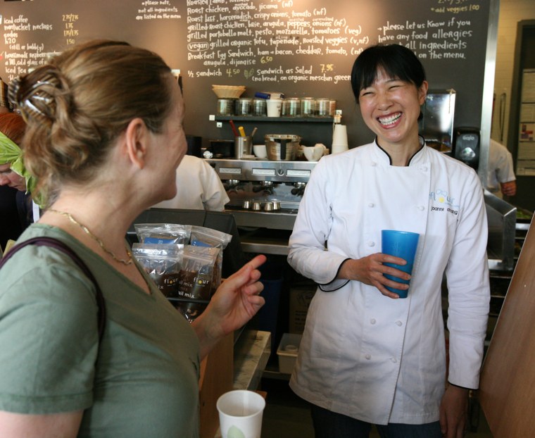 Pastry chef and owner of Flour bakeries in Boston Joanne Chang talks with a customer in her Cambridge, Mass. location.