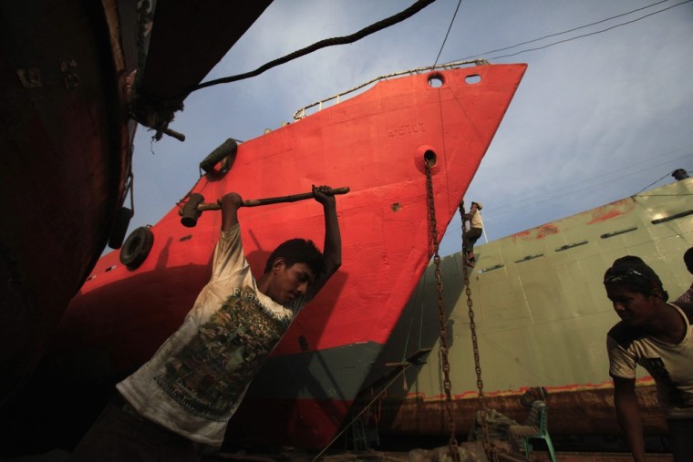 Workers work in a shipyard by the river Buriganga, on the outskirt of Dhaka.
