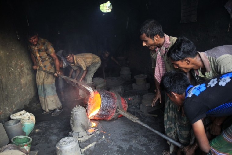 Workers make ship propellers at a metal workshop in a shipyard by the river Buriganga, on the outskirt of Dhaka.