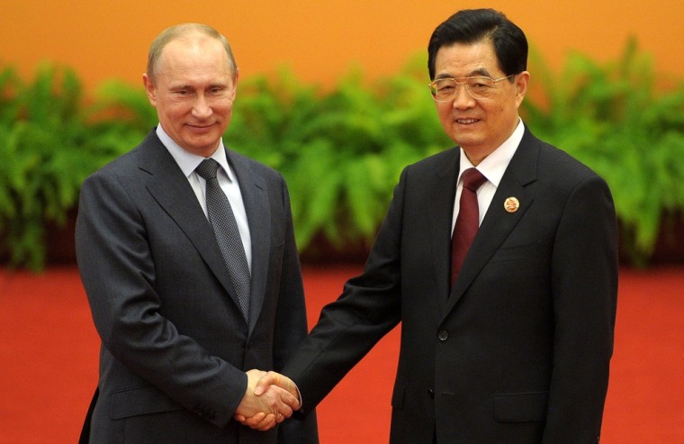 Russia's President Vladimir Putin and Chinese President Hu Jintao shake hands before a meeting at a summit of the Shanghai Cooperation Organization in Beijing, on Thursday.