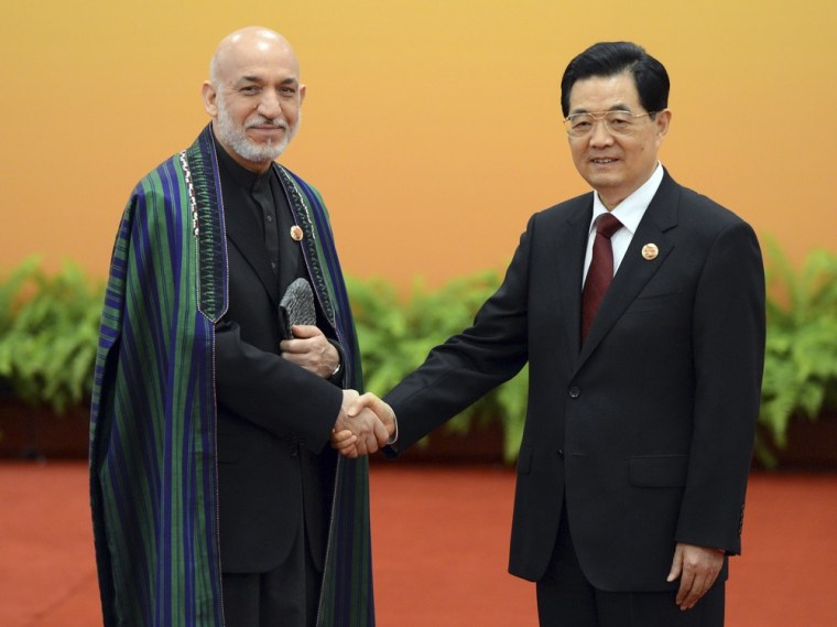 Chinese President Hu Jintao greets Afghanistan President Hamid Karzai at the Shanghai Cooperation Organization summit in the Great Hall of the People in Beijing on Thursday.