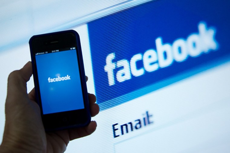 A view of and Apple iPhone displaying the Facebook app's splash screen.