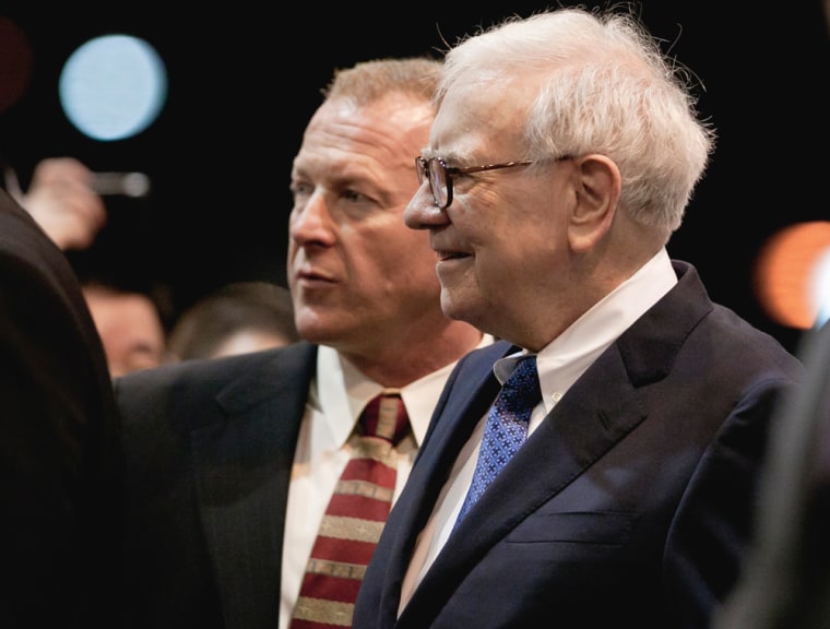 Warren Buffett, chairman and CEO of Berkshire Hathaway, center right, tours the exhibitor's floor with his chief of security Dan Clark, prior to holding the Berkshire Hathaway shareholders meeting in Omaha, Neb., Saturday, May 5, 2012.