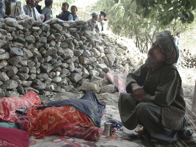 An Afghan man mourns the death of relatives after an earthquake hit the Baghlan province, north of Kabul, Afghanistan, Monday, June 11, 2012.