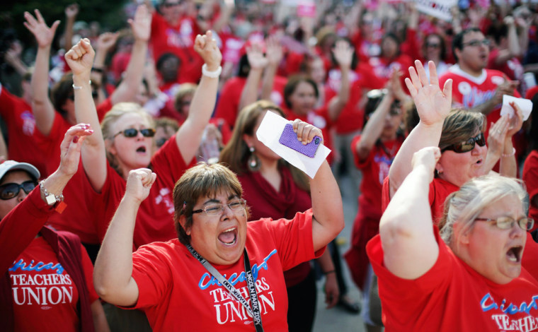 Thousands of Chicago Public School teachers rally before marching to the Board of Education's headquarters in protest in Chicago on May 23. Teachers say they are upset with contract talks, especially the offered 2 percent raise to work a longer school day this fall.