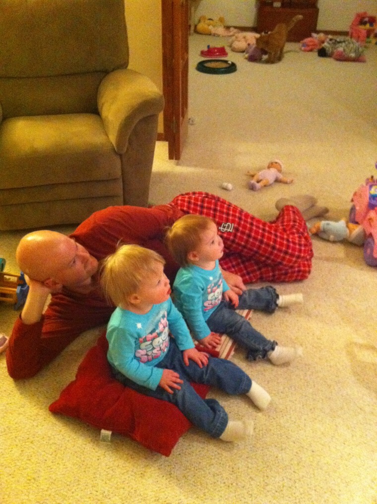 Daddy watching TV with his girls, 3 year old twins Marley and Chloe