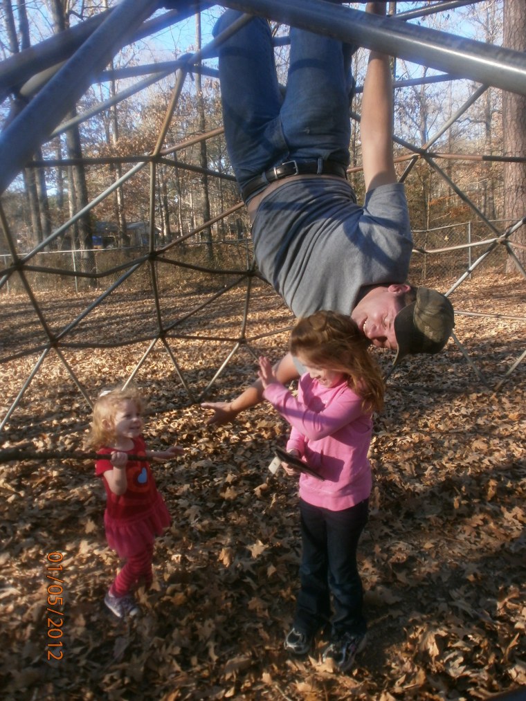 Daddy hanging with kids Elyssa, 7, and Alana, 2, at the park.