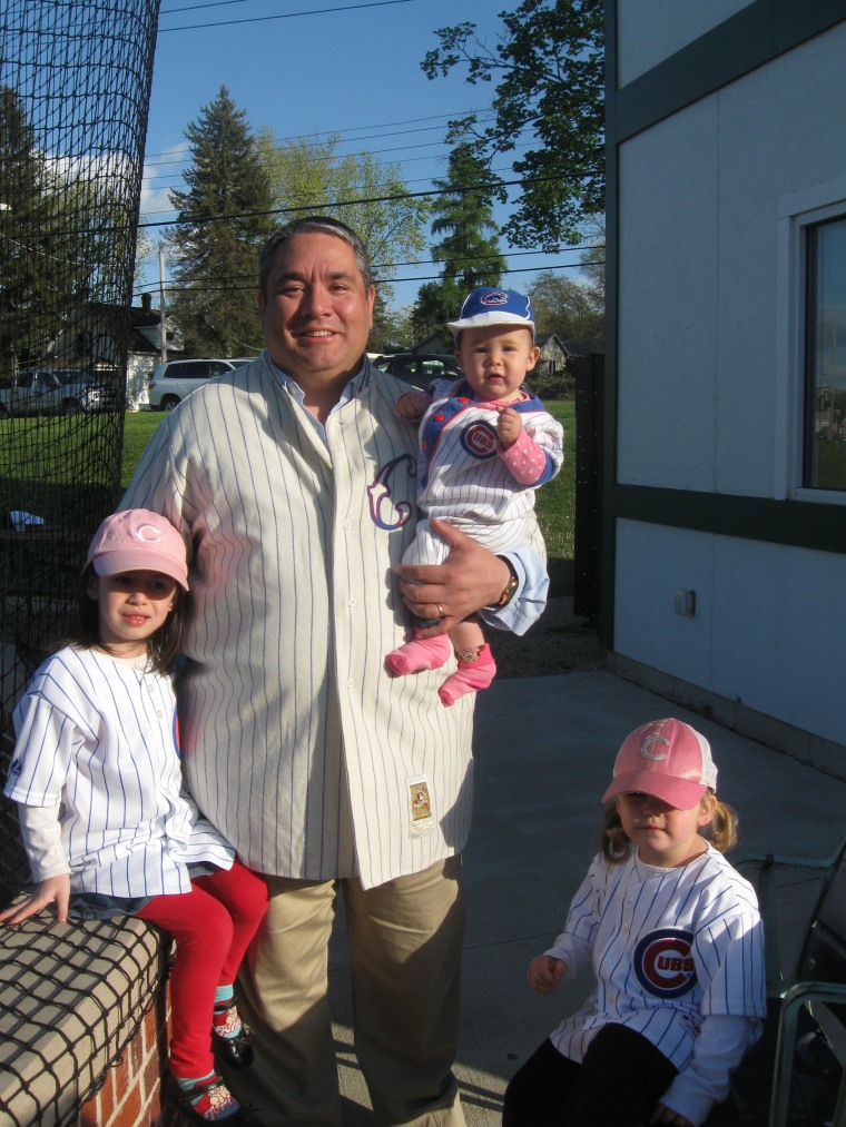 Dad and his three girls -- Cecilia, Olivia, Sofia, enjoy  Daddy time at a baseball game.