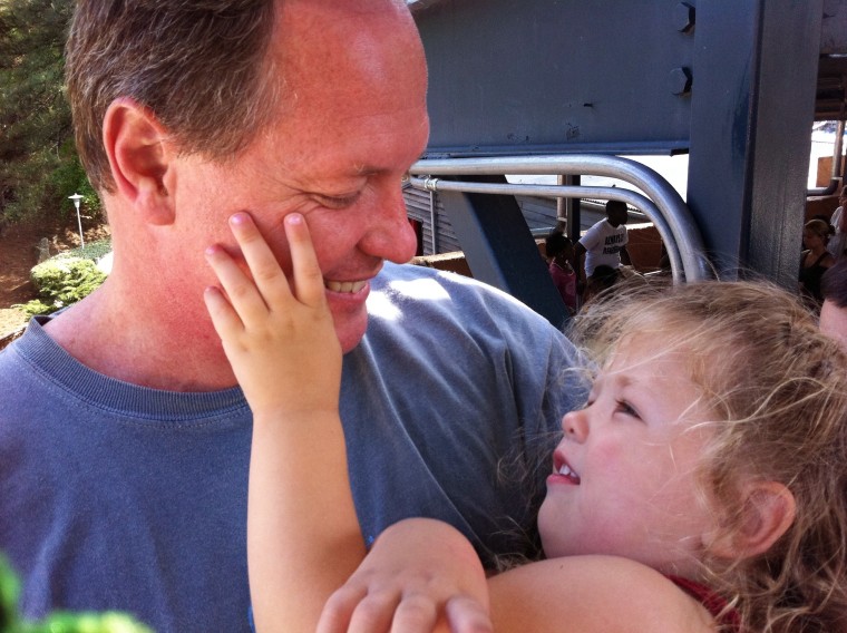 Claire, 3, has Daddy hold her after a day at the amusement park.